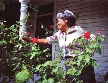 Miss Mercado enjoys her roses.